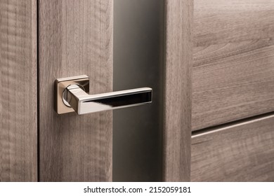 Close up of stylish silver chrome door handle on modern interior door. Stylish light brown door with frosted glass inserts. Concept of catalog of door handles for furniture store. - Powered by Shutterstock
