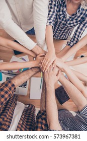 Close up of successful group of businesspeople putting hands together. - Shutterstock ID 573967381