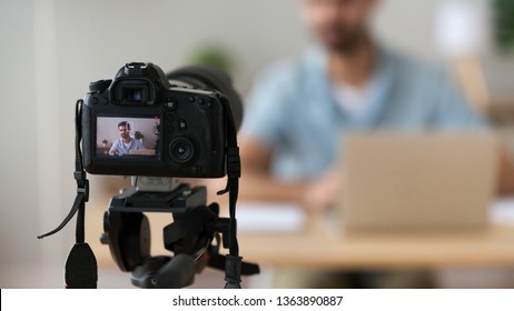 Close up successful man recording video, using digital camera in office or at home, successful freelancer, modern blogger, business coach making content, using professional equipment - Powered by Shutterstock