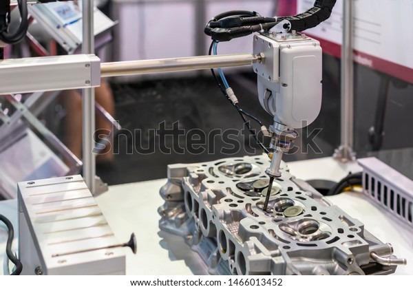 close up suction head and valve\
shaft during catch remove or assembly in cylinder block engine of\
vehicle or automobile by automation pneumatic system\
control