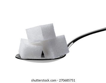 Close Up Of Sugar Cubes In A Spoon On White Background