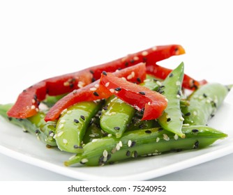 Close Up Of Sugar Snap Pea Salad Garnished With Sliced Red Pepper And Sesame Seeds; Narrow Depth Of Field;