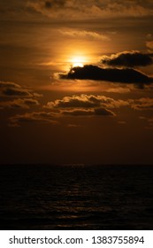 Close up the sun with cloud in front of it at the sunset twilight time.
