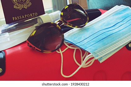 Close Up Of Sunglasses With Surgical Mask, Sanitizer Bottle Over A Suitcase, Concept Of Traveling During Corona Virus