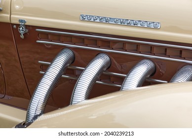 Close up of Super Charged V8 Vintage vehicle, exhaust pipes