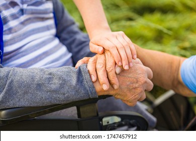 Close up of supporting hand to care elderly couple.