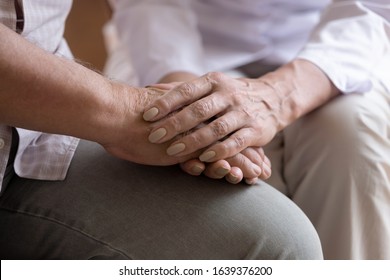 Close Up Of Supportive Female Nurse Or Psychologist Hold Mature Male Patient Hands Show Care And Understanding, Woman Doctor Support Senior Man Client Comforting Him, Elderly Healthcare Concept