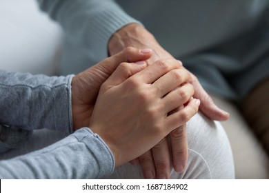 Close Up Of Supportive Grown-up Daughter Hug Elderly Mom Hand Talk Share Close Intimate Moment Together, Loving Adult Girl Child Comfort Mature Mother Show Care And Support, Family Unity Concept