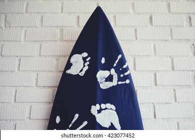 close up surfboard set on the white brick wall - Powered by Shutterstock