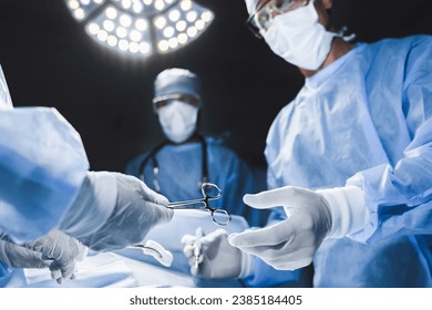 Close up of surgery team operating in modern hospital. Medical workers teamwork, saving rescuing patient`s life during plastic cardio surgery. Organs transplantation