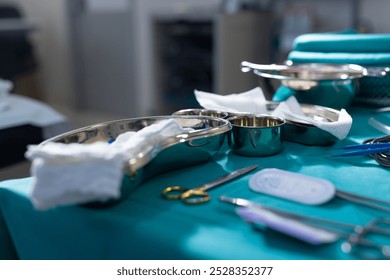Close up of surgical instruments on table in operation theater at hospital. Hospital, surgery, medicine and healthcare.