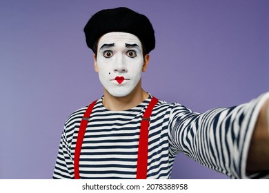 Close Up Surprised Young Mime Man With White Face Mask Wears Striped Shirt Beret Looking Camera Doing Selfie Shot Pov On Mobile Phone Isolated On Plain Pastel Light Violet Background Studio Portrait