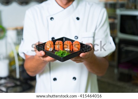 Close up Sushi in chefs hands. Focus on sushi