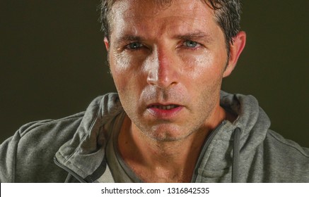 Close Up Sweaty Face Portrait Of Young Attractive And Fierce Looking Man Wearing Sport Sweater Posing In Aggressive And Defiant Attitude Isolated On Dark Background In Sport And Fitness 