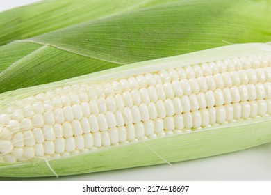 close up of sweet white corn cobs background