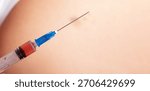 Close up of a syringe with needle and clear solution against human skin, suitable for healthcare and vaccination concepts.