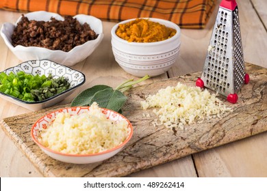 Close Up Of Table With Ingredients For Beef Pumpkin Pinwheels. Cheese, Fresh Sage, Pumpkin Puree, Fried Ground Beef.