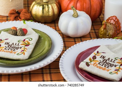 Close Up Of Table Set With Colorful Plates And Center Piece Arrangement For Thanksgiving Party.