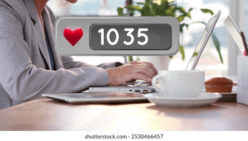 Close up of a table with two people working on their laptops opposite each other. A like count box is increasing in number in the foreground 4k - Powered by Shutterstock