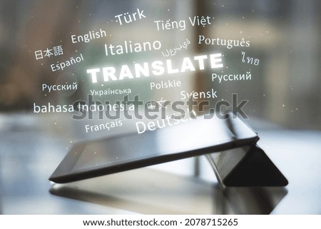 Close up of tablet with abstract text on blurry background. Translation, foreign language, service and education concept. Double exposure