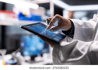 Close up of tablet running laboratory experiments in chemistry and biology. Healthcare technology and medical research data highlight advanced research in diagnostics and pharmacology.