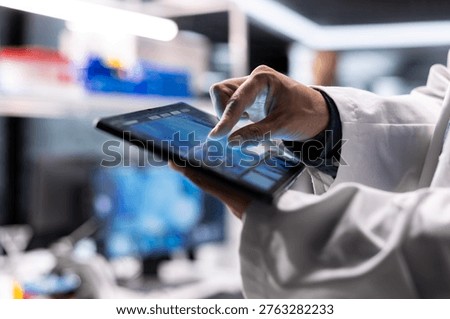 Close up of tablet running laboratory experiments in chemistry and biology. Healthcare technology and medical research data highlight advanced research in diagnostics and pharmacology.