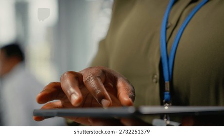 Close up of tablet used by programmer in office to accelerate complex artificial intelligence calculations. IT employee using touchscreen device to train deep learning datasets systems, camera B