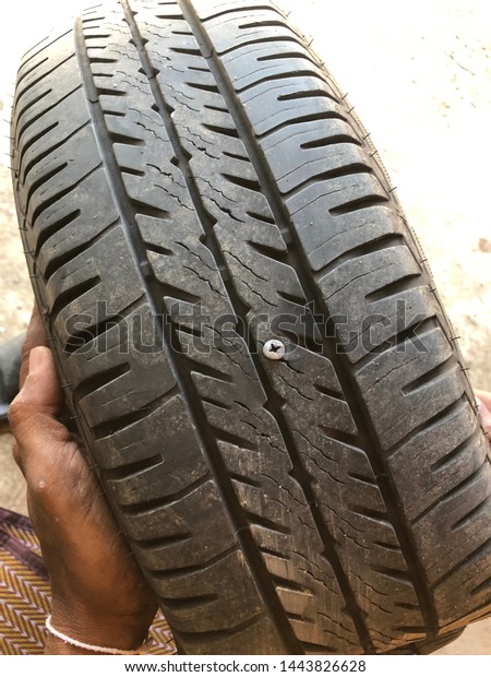 Close up tack in tire ,Flat tire The\
tire is leaking from the nail Can a Tire be\
Repaired