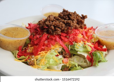 Close Up Of A Taco Salad On A White Round Plate