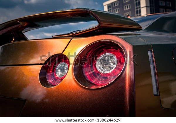 Close up of tail light detail of modern luxury\
sports car with reflection on chameleon paint after wash &\
wax. Rear view of supercar break led lights. Concept of car\
detailing and paint\
protection