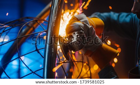 Close Up of a Talented Innovative Artist Using an Angle Grinder to Make an Abstract, Brutal and Expressive Metal Sculpture in a Workshop. Contemporary Fabricator Creating Modern Steel Art.