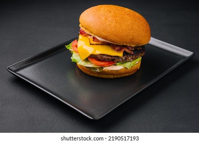 Close Up Tall Tasty Burger With Cheese Served On Tray