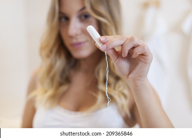 Close Up Of Tampon In Hand Of Blonde Woman 