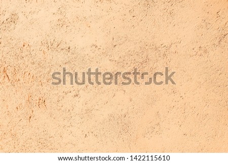close up tan cement cracked wall background texture