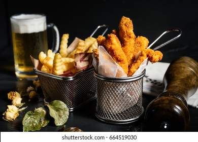 Close Up Of Tasty, Mouth-watering Fresh Chicken Fingers With Fries And Beer