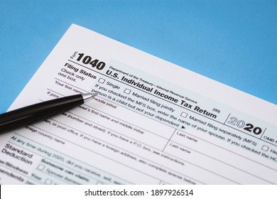 Close Up Of Tax Form 1040 On Light Blue Background