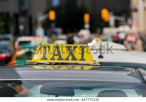 Close up of a\
taxi roof sign in Toronto,\
Canada