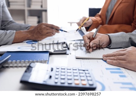 Close up Team of colleagues discussing business Accounting using calculating income-expenditure and calculator analyzing real estate investment data report Financial and tax systems concept. ストックフォト © 