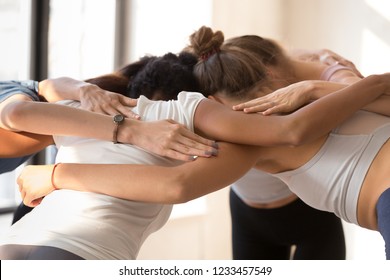 Close Up Of Team Diverse Girls Embracing Standing In Circle Having Motivational Pep Talk Before Match Indoors. Multi-ethnic Females Congratulating Each Other After Sports Training Hugging Feels Happy