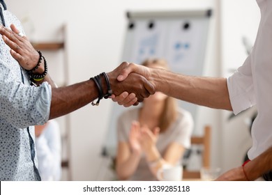 Close Up Team Leader Congratulating African American Employee With Job Promotion, Business Achievement, Thanking For Great Work Results At Company Meeting, Showing Respect, Colleagues Applauding