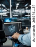 Close up of technician in data center using AI LLM assistant on laptop to perform maintenance on hardware rigs. Server farm IT specialist using large language model chatbot on notebook to do backups