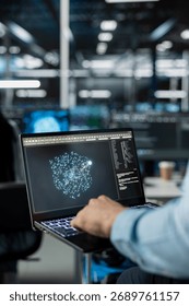 Close up of technician in data center using AI LLM assistant on laptop to perform maintenance on hardware rigs. Server farm IT specialist using large language model chatbot on notebook to do backups