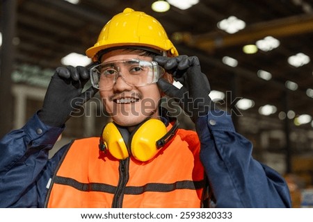 Close up technician engineer wearing and adjust protective safety glasses. Safety equipment for industry factory. Safety at work concept.