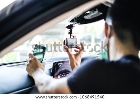 Close up Technician Hand with Car Camera and Smartphone Inside Car and Blur Man as a Foreground