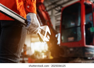 Close Up Of A Technician Hand Holding A Tool For Maintenance Or Machine Service In The Workshop. Heavy Duty Equipment Maintenance. Industrial Concept. 