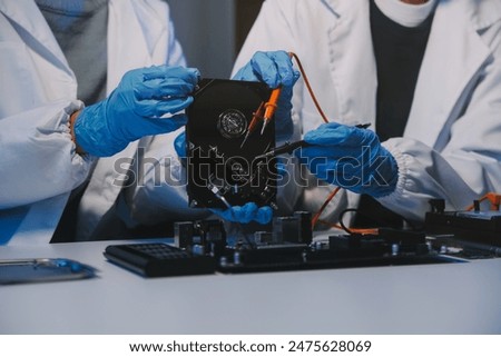 Close up of Technician measuring voltage electronic circuit board television, Service after sale fix electric equipment within insurance.