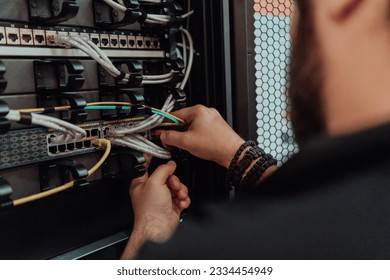 Close up of technician setting up network in server room 