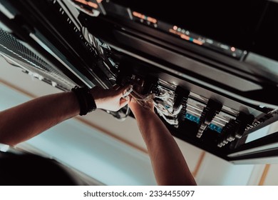 Close up of technician setting up network in server room 
