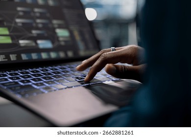 Close up of technician using laptop to do programming in server farm housing infrastructure storing datasets. IT specialist typing on notebook keyboard, coding, repairing data center racks