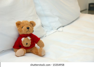 Close up of teddy bear in bed